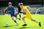 11 June 2025; Pauric Doherty of Scoil Íosagáin, Buncrana, Inishowen, Donegal, in action against Harley Christie of Lusk SNS, Dublin, during the FAI Primary 5s Finals Day at the Aviva Stadium in Dublin. Photo by Seb Daly/Sportsfile