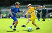 11 June 2025; Dylan Maguire of Lusk SNS, Dublin, in action against Harry McGeough of Scoil Íosagáin, Buncrana, Inishowen, Donegal, during the FAI Primary 5s Finals Day at the Aviva Stadium in Dublin. Photo by Seb Daly/Sportsfile