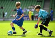 11 June 2025; Harry Gleeson of Lusk SNS, Dublin, in action against Shane McLaughlin of Scoil Íosagáin, Buncrana, Inishowen, Donegal, during the FAI Primary 5s Finals Day at the Aviva Stadium in Dublin. Photo by Seb Daly/Sportsfile