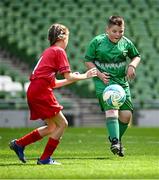 11 June 2025; Johnny McDonagh of St Mary’s BNS, Maynooth, Kildare, in action against Ellie Murphy of St Columba’s NS, Cork, during the FAI Primary 5s Finals Day at the Aviva Stadium in Dublin. Photo by Seb Daly/Sportsfile