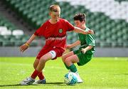 11 June 2025; Harry Randles of Scoil Niocláis, Corcaigh, in action against Max Dooley of Scoil Íosa, Oranmore, Galway, during the FAI Primary 5s Finals Day at the Aviva Stadium in Dublin. Photo by Seb Daly/Sportsfile