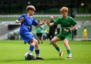 11 June 2025; Harry Gleeson of Lusk SNS, Dublin, in action against Kyle Cormican of Scoil Íosa, Oranmore, Galway, during the FAI Primary 5s Finals Day at the Aviva Stadium in Dublin. Photo by Seb Daly/Sportsfile