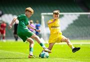 11 June 2025; Kyle Cormican of Scoil Íosa, Oranmore, Galway, in action against Pauric Doherty of Scoil Íosagáin, Buncrana, Inishowen, Donegal, during the FAI Primary 5s Finals Day at the Aviva Stadium in Dublin. Photo by Seb Daly/Sportsfile