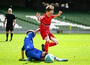 11 June 2025; Darragh Fields of Scoil Niocláis, Corcaigh, is tackled by Dylan Maguire of Lusk SNS, Dublin, during the FAI Primary 5s Finals Day at the Aviva Stadium in Dublin. Photo by Seb Daly/Sportsfile