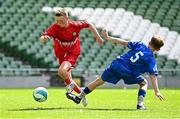 11 June 2025; Harry Randles of Scoil Niocláis, Corcaigh, in action against Harry Gleeson of Lusk SNS, Dublin, during the FAI Primary 5s Finals Day at the Aviva Stadium in Dublin. Photo by Seb Daly/Sportsfile
