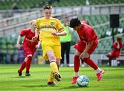 11 June 2025; Danny Bradley of Scoil Íosagáin, Buncrana, Inishowen, Donegal, in action against Zaroon Abbasi of Catherine McAuley School, Limerick, during the FAI Primary 5s Finals Day at the Aviva Stadium in Dublin. Photo by Seb Daly/Sportsfile