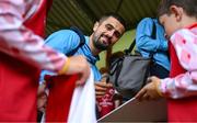 13 June 2025; Zach Elbouzedi of St Patrick's Athletic signs autographs for supporters before the SSE Airtricity Men's Premier Division match between St Patrick's Athletic and Drogheda United at Richmond Park in Dublin. Photo by Shauna Clinton/Sportsfile