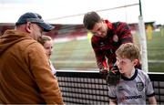 13 June 2025; Derry City goalkeeper Brian Maher signs the jersey of Derry City supporter Cormac Gallagher before the SSE Airtricity Men's Premier Division match between Derry City and Galway United at The Ryan McBride Brandywell Stadium in Derry. Photo by Ramsey Cardy/Sportsfile