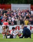 13 June 2025; Kian Leavy of St Patrick's Athletic receives medical attention after being fouled by Douglas James-Taylor of Drogheda United during the SSE Airtricity Men's Premier Division match between St Patrick's Athletic and Drogheda United at Richmond Park in Dublin. Photo by Shauna Clinton/Sportsfile