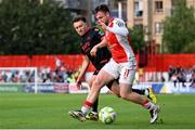 13 June 2025; Jay McClelland of St Patrick's Athletic in action against Darragh Markey of Drogheda United during the SSE Airtricity Men's Premier Division match between St Patrick's Athletic and Drogheda United at Richmond Park in Dublin. Photo by Shauna Clinton/Sportsfile