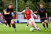 13 June 2025; Jay McClelland of St Patrick's Athletic in action against Drogheda United players George Cooper, left, and Darragh Markey during the SSE Airtricity Men's Premier Division match between St Patrick's Athletic and Drogheda United at Richmond Park in Dublin. Photo by Shauna Clinton/Sportsfile