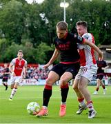 13 June 2025; Jay McClelland of St Patrick's Athletic tackles George Cooper of Drogheda United during the SSE Airtricity Men's Premier Division match between St Patrick's Athletic and Drogheda United at Richmond Park in Dublin. Photo by Shauna Clinton/Sportsfile