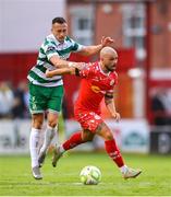 13 June 2025; Mark Coyle of Shelbourne in action against Aaron McEneff of Shamrock Rovers during the SSE Airtricity Men's Premier Division match between Shelbourne and Shamrock Rovers at Tolka Park in Dublin. Photo by Stephen McCarthy/Sportsfile