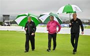 14 June 2025; Umpires, from left, Mark Hawthorne, Aidan Seaver and Johnny Kennedy inspect the pitch before abandoning match two of the T20 International Series between Ireland and the West Indies at Bready Cricket Club in Magheramason, Tyrone. Photo by Sam Barnes/Sportsfile