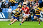 14 June 2025; Ben O'Carroll of Roscommon in action against Seán Brady of Cork during the GAA Football All-Ireland Senior Championship Round 3 match between Roscommon and Cork at Laois Hire O'Moore Park in Portlaoise, Laois. Photo by Daire Brennan/Sportsfile