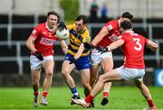 14 June 2025; Brian Stack of Roscommon in action against Cork players, left to right, Sean Meehan, Colm O'Callaghan, and Daniel O'Mahony during the GAA Football All-Ireland Senior Championship Round 3 match between Roscommon and Cork at Laois Hire O'Moore Park in Portlaoise, Laois. Photo by Daire Brennan/Sportsfile