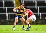 14 June 2025; Ben O'Carroll of Roscommon in action against Seán Brady of Cork during the GAA Football All-Ireland Senior Championship Round 3 match between Roscommon and Cork at Laois Hire O'Moore Park in Portlaoise, Laois. Photo by Daire Brennan/Sportsfile