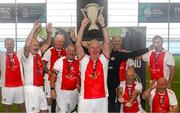 14 June 2025; St Patrick's Athletic captain Bracey Daniels lifts the cup after winning the League of Ireland Walking Football Festival at the National Indoor Arena on the Sport Ireland Campus in Dublin. Photo by Stephen McCarthy/Sportsfile