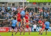 14 June 2025; Peadar Ó Cofaigh Byrne of Dublin in action against Dan Higgins and Conor Glass of Derry during the GAA Football All-Ireland Senior Championship Round 3 match between Dublin and Derry at Páirc Esler in Newry, Down. Photo by Ramsey Cardy/Sportsfile