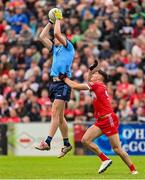 14 June 2025; Peadar Ó Cofaigh Byrne of Dublin in action against Dan Higgins of Derry during the GAA Football All-Ireland Senior Championship Round 3 match between Dublin and Derry at Páirc Esler in Newry, Down. Photo by Ramsey Cardy/Sportsfile