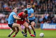 14 June 2025; Shane McGuigan of Derry in action against Dublin players, from left, Sean Bugler and Brian Howard during the GAA Football All-Ireland Senior Championship Round 3 match between Dublin and Derry at Páirc Esler in Newry, Down. Photo by Thomas Flinkow/Sportsfile