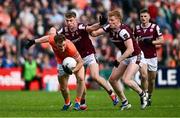14 June 2025; Jason Duffy of Armagh is tackled by Dylan McHugh, left, and Peter Cooke of Galway during the GAA Football All-Ireland Senior Championship Round 3 match between Galway and Armagh at Kingspan Breffni in Cavan. Photo by Ben McShane/Sportsfile