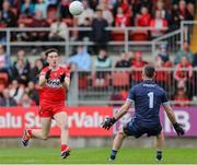 14 June 2025; Paul Cassidy of Derry on his way to scoring a point past Dublin goalkeeper Stephen Cluxton  during the GAA Football All-Ireland Senior Championship Round 3 match between Dublin and Derry at Páirc Esler in Newry, Down. Photo by Thomas Flinkow/Sportsfile