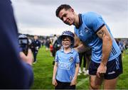 14 June 2025; A young supporter has his photo taken with David Byrne of Dublin after the GAA Football All-Ireland Senior Championship Round 3 match between Dublin and Derry at Páirc Esler in Newry, Down. Photo by Thomas Flinkow/Sportsfile