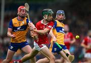 15 June 2025; Jack Counihan of Cork in action against Niall Doyle of Clare during the Electric Ireland GAA Hurling All-Ireland Minor Championship semi-final match between Cork and Clare at FBD Semple Stadium in Thurles, Tipperary. Photo by Brendan Moran/Sportsfile