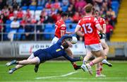 15 June 2025; Craig Lennon of Louth gets past Clare goalkeeper Eamon Tubridy to have a shot on goal during the GAA Football All-Ireland Senior Championship Round 3 match between Louth and Clare at Laois Hire O'Moore Park in Portlaoise, Laois. Photo by Shauna Clinton/Sportsfile