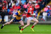 15 June 2025; Ciaran Downey of Louth in action against Cillian Rouine of Clare during the GAA Football All-Ireland Senior Championship Round 3 match between Louth and Clare at Laois Hire O'Moore Park in Portlaoise, Laois. Photo by Shauna Clinton/Sportsfile