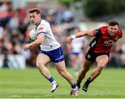 15 June 2025; Mícheál Bannigan of Monaghan in action against Pierce Laverty of Down during the GAA Football All-Ireland Senior Championship Round 3 match between Monaghan and Down at BOX-IT Athletic Grounds in Armagh. Photo by Thomas Flinkow/Sportsfile