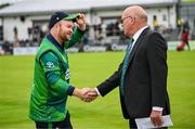 15 June 2025; Paul Stirling of Ireland and match referee Jeff Crowe before match three of the T20 International Series between Ireland and the West Indies at Bready Cricket Club in Magheramason, Tyrone. Photo by Ramsey Cardy/Sportsfile