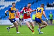 15 June 2025; Ciaran Downey of Louth is tackled by Eoin Cleary of Clare during the GAA Football All-Ireland Senior Championship Round 3 match between Louth and Clare at Laois Hire O'Moore Park in Portlaoise, Laois. Photo by Shauna Clinton/Sportsfile