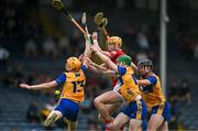 15 June 2025; Ruairc Donovan of Cork contests a dropping ball with Clare players, from left, Ian O'Brien, Darragh Murrihy and Evan Crimmins during the Electric Ireland GAA Hurling All-Ireland Minor Championship semi-final match between Cork and Clare at FBD Semple Stadium in Thurles, Tipperary. Photo by Brendan Moran/Sportsfile