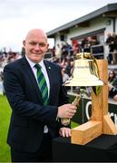 15 June 2025; Former Ireland international Peter Gillespie rings the Roy Torrens bell before match three of the T20 International Series between Ireland and the West Indies at Bready Cricket Club in Magheramason, Tyrone. Photo by Ramsey Cardy/Sportsfile