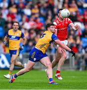 15 June 2025; Tommy Durnin of Louth is tackled by Ronan Lanigan of Clare during the GAA Football All-Ireland Senior Championship Round 3 match between Louth and Clare at Laois Hire O'Moore Park in Portlaoise, Laois. Photo by Shauna Clinton/Sportsfile