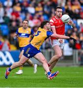 15 June 2025; Tommy Durnin of Louth is tackled by Ronan Lanigan of Clare during the GAA Football All-Ireland Senior Championship Round 3 match between Louth and Clare at Laois Hire O'Moore Park in Portlaoise, Laois. Photo by Shauna Clinton/Sportsfile