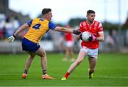 15 June 2025; Ciaran Downey of Louth is tackled by Manus Doherty of Clare during the GAA Football All-Ireland Senior Championship Round 3 match between Louth and Clare at Laois Hire O'Moore Park in Portlaoise, Laois. Photo by Shauna Clinton/Sportsfile