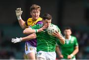 15 June 2025; Iain Corbett of Limerick is tackled by Jack Higgins of Wexford during the Tailteann Cup quarter-final match between Limerick and Wexford at TUS Gaelic Grounds in Limerick. Photo by Tom Beary/Sportsfile