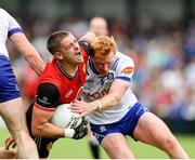 15 June 2025; Pat Havern of Down is tackled by Ryan O'Toole of Monaghan during the GAA Football All-Ireland Senior Championship Round 3 match between Monaghan and Down at BOX-IT Athletic Grounds in Armagh. Photo by Thomas Flinkow/Sportsfile