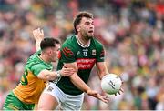 15 June 2025; Aidan O’Shea of Mayo in action against Caolan McColgan of Donegal during the GAA Football All-Ireland Senior Championship Round 3 match between Donegal and Mayo at King & Moffatt Dr Hyde Park in Roscommon. Photo by Seb Daly/Sportsfile