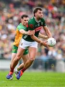 15 June 2025; Aidan O’Shea of Mayo in action against Caolan McColgan of Donegal during the GAA Football All-Ireland Senior Championship Round 3 match between Donegal and Mayo at King & Moffatt Dr Hyde Park in Roscommon. Photo by Seb Daly/Sportsfile