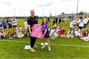 15 June 2025; FAI board member Laura Finnegan O’Halloran presents a jersey to Martha Murray during the Honouring Every Woman event at Graun Park in Tramore AFC, Waterford. Photo by Matt Browne/Sportsfile