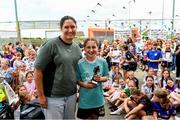 15 June 2025; Hannah Dingley, FAI Head of Women & Girls' Football presents the under-12 players of the year trophy to Finola Carraghrt during the Honouring Every Woman event at Graun Park in Tramore AFC, Waterford. Photo by Matt Browne/Sportsfile