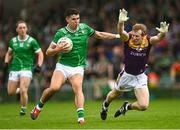 15 June 2025; Emmett Rigter of Limerick is tackled by Michael Furlong of Wexford during the Tailteann Cup quarter-final match between Limerick and Wexford at TUS Gaelic Grounds in Limerick. Photo by Tom Beary/Sportsfile
