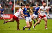 15 June 2025; Ciarán Brady of Cavan is tackled by Darren McCurry of Tyrone during the GAA Football All-Ireland Senior Championship Round 3 match between Tyrone and Cavan at Brewster Park in Enniskillen, Fermanagh. Photo by Ben McShane/Sportsfile