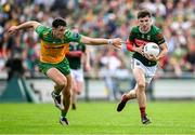 15 June 2025; Enda Hession of Mayo in action against Michael Langan of Donegal during the GAA Football All-Ireland Senior Championship Round 3 match between Donegal and Mayo at King & Moffatt Dr Hyde Park in Roscommon. Photo by Seb Daly/Sportsfile