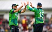 15 June 2025; Ross Adair of Ireland is congratulated by Liam McCarthy, left, after claiming the wicket of Jason Holder of West Indies during match three of the T20 International Series between Ireland and the West Indies at Bready Cricket Club in Magheramason, Tyrone. Photo by Ramsey Cardy/Sportsfile