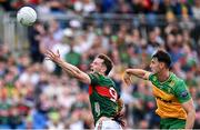 15 June 2025; Matthew Ruane of Mayo in action against Michael Langan of Donegal during the GAA Football All-Ireland Senior Championship Round 3 match between Donegal and Mayo at King & Moffatt Dr Hyde Park in Roscommon. Photo by Seb Daly/Sportsfile